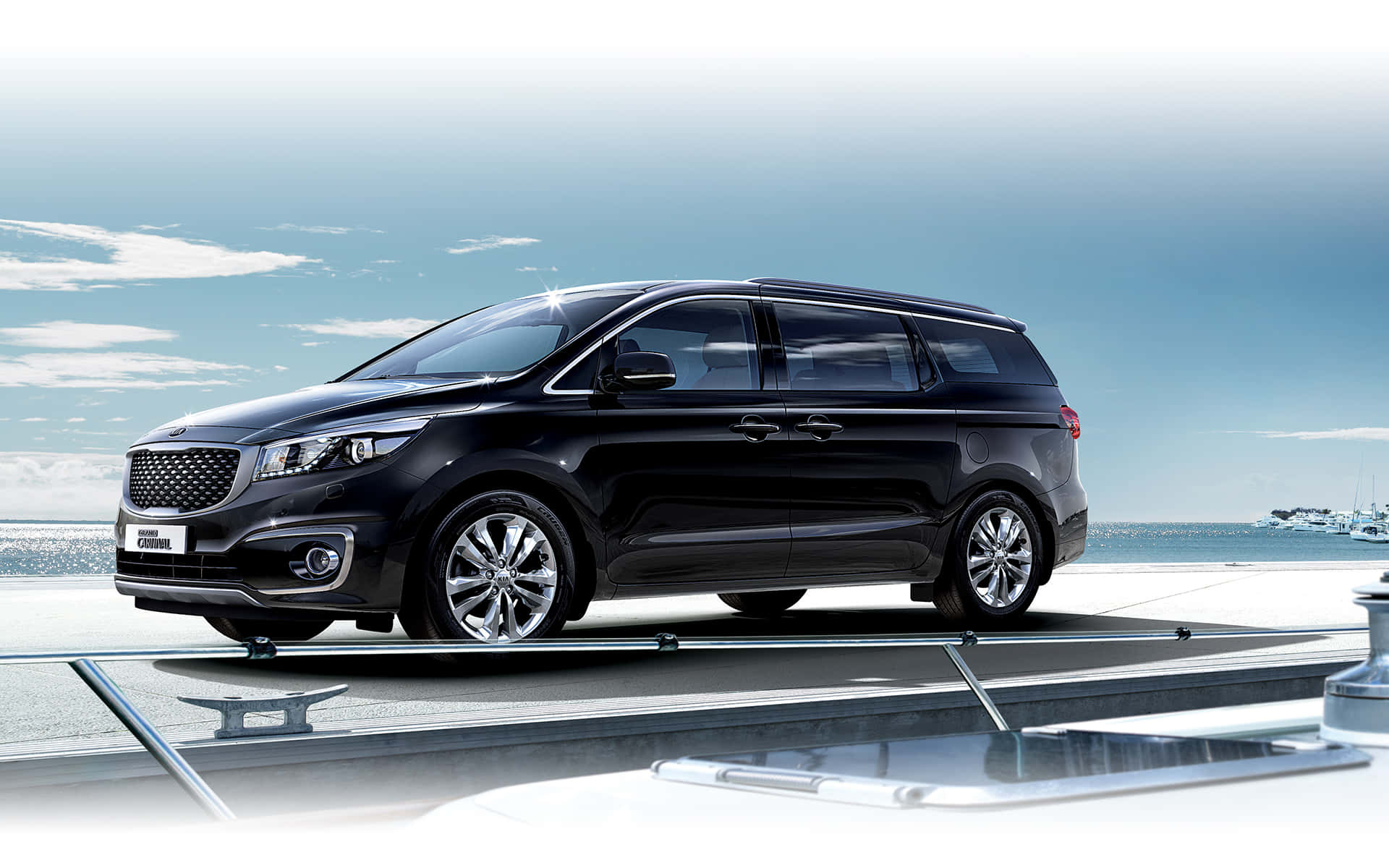 Luxurious Kia Carnival Dominating The Roadway Wallpaper