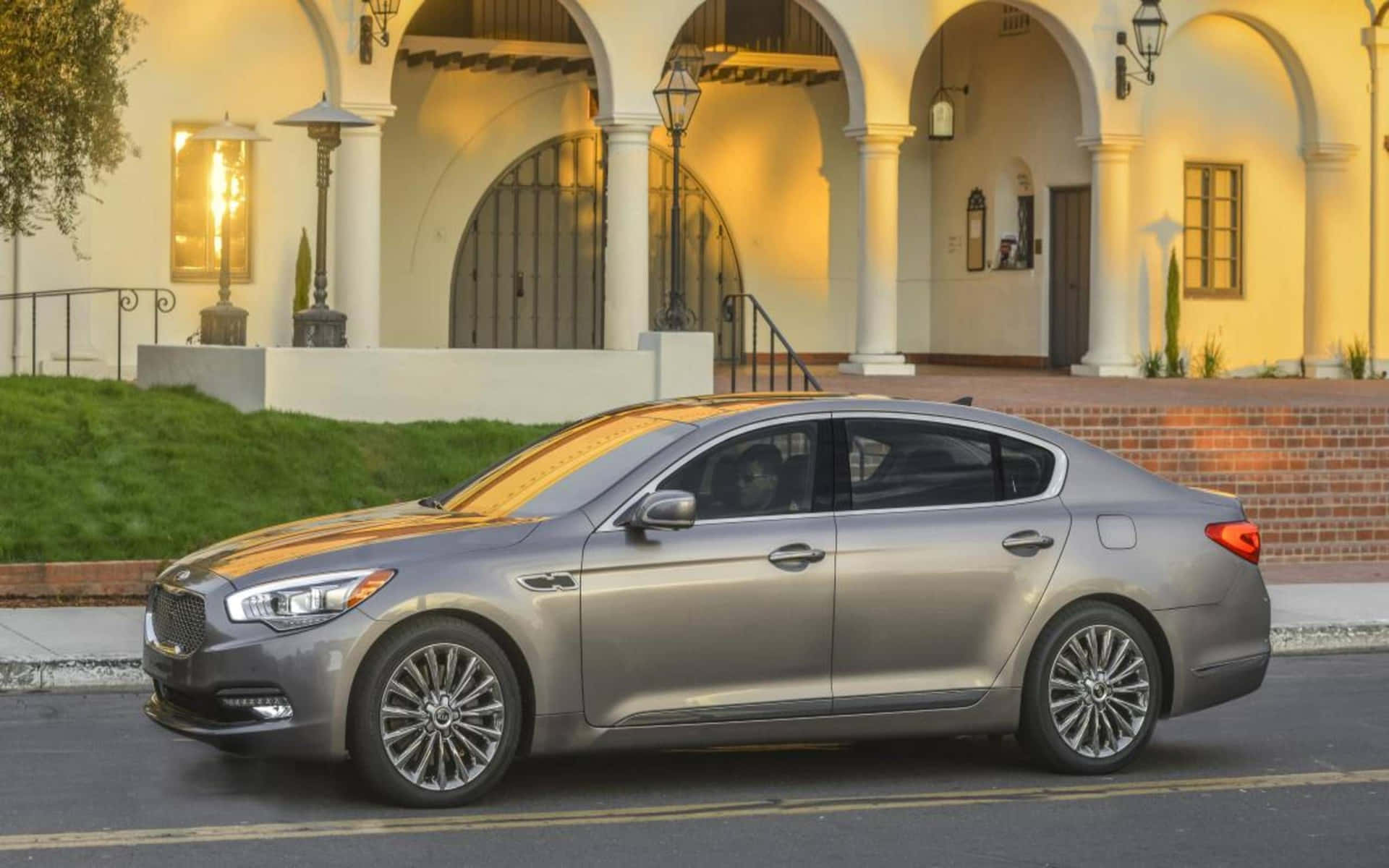 Luxurious Kia K900 Gliding In A Serene Landscape Wallpaper