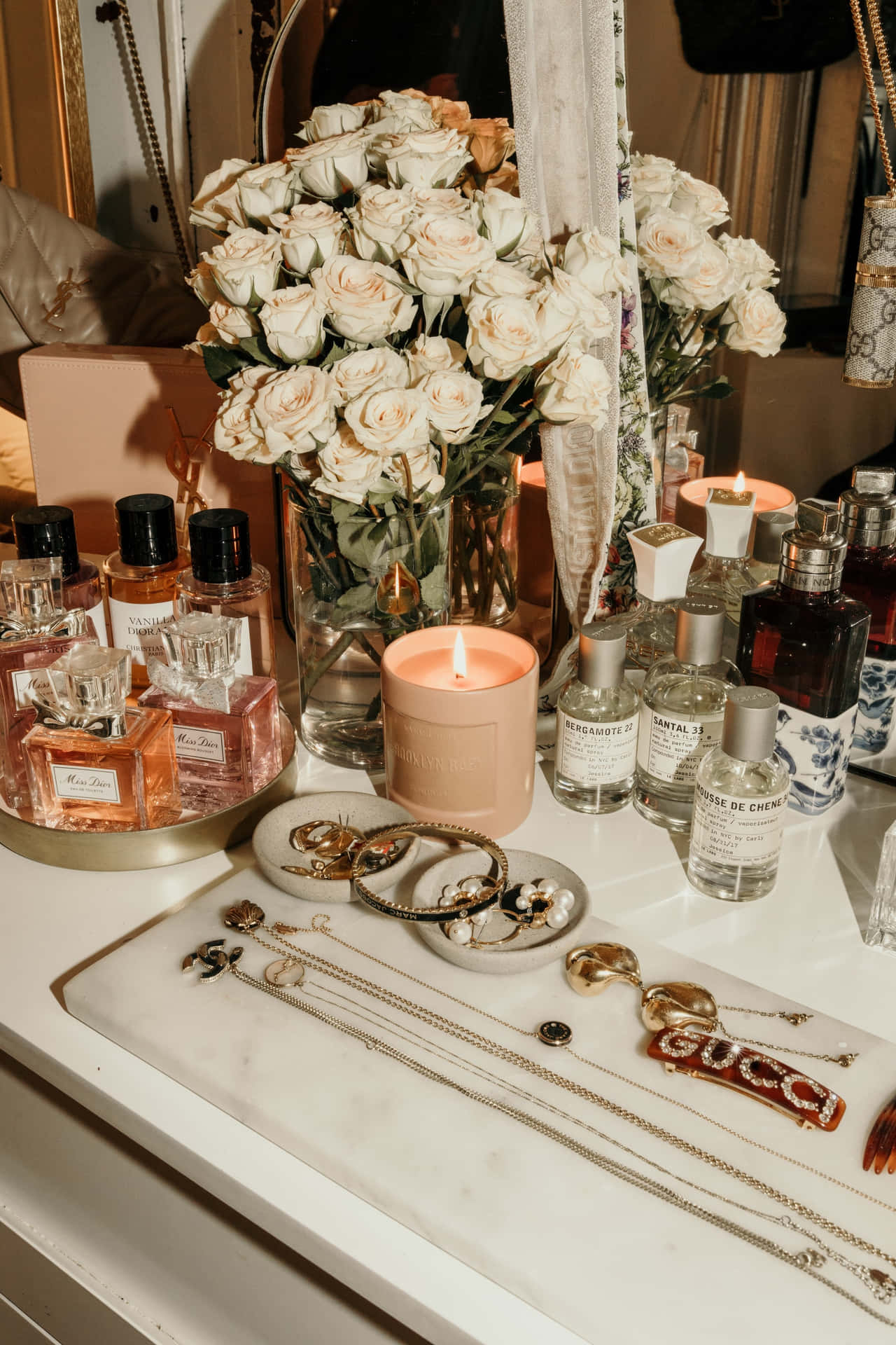 Luxurious Vanity Setupwith Flowersand Perfumes Wallpaper