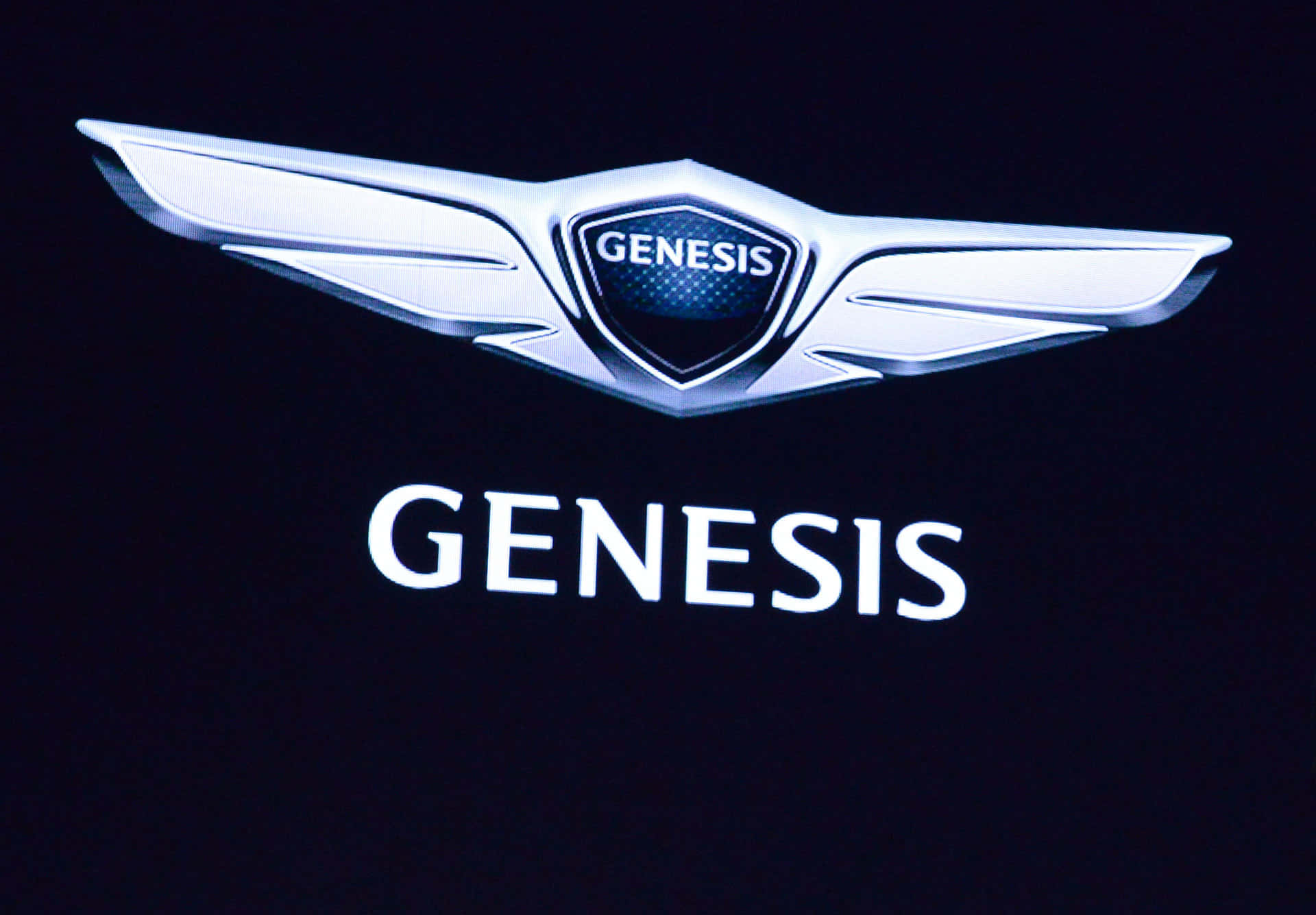 a genesis logo is shown on a black background Wallpaper