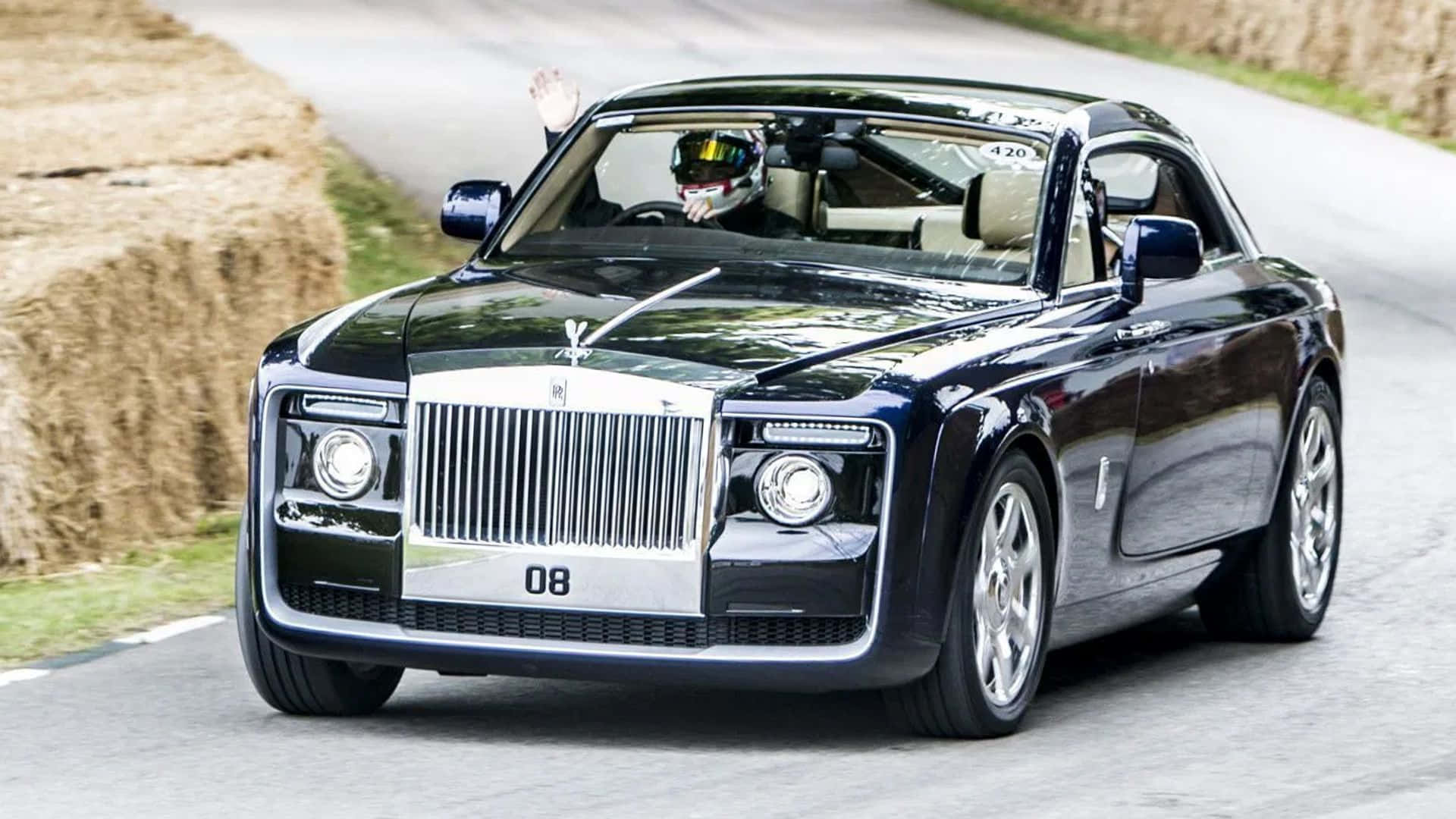 Luxury Defined: Rolls Royce Sweptail Against A Rustic Backdrop Wallpaper