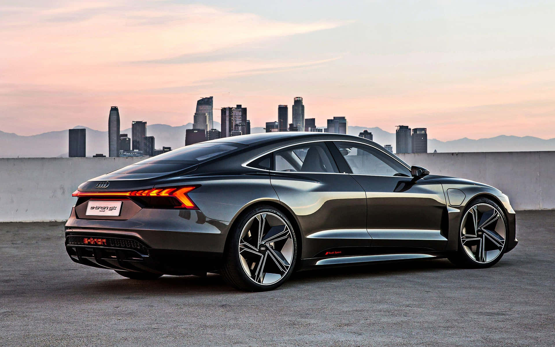 Luxury Electric Coupe Sunset Cityscape Wallpaper