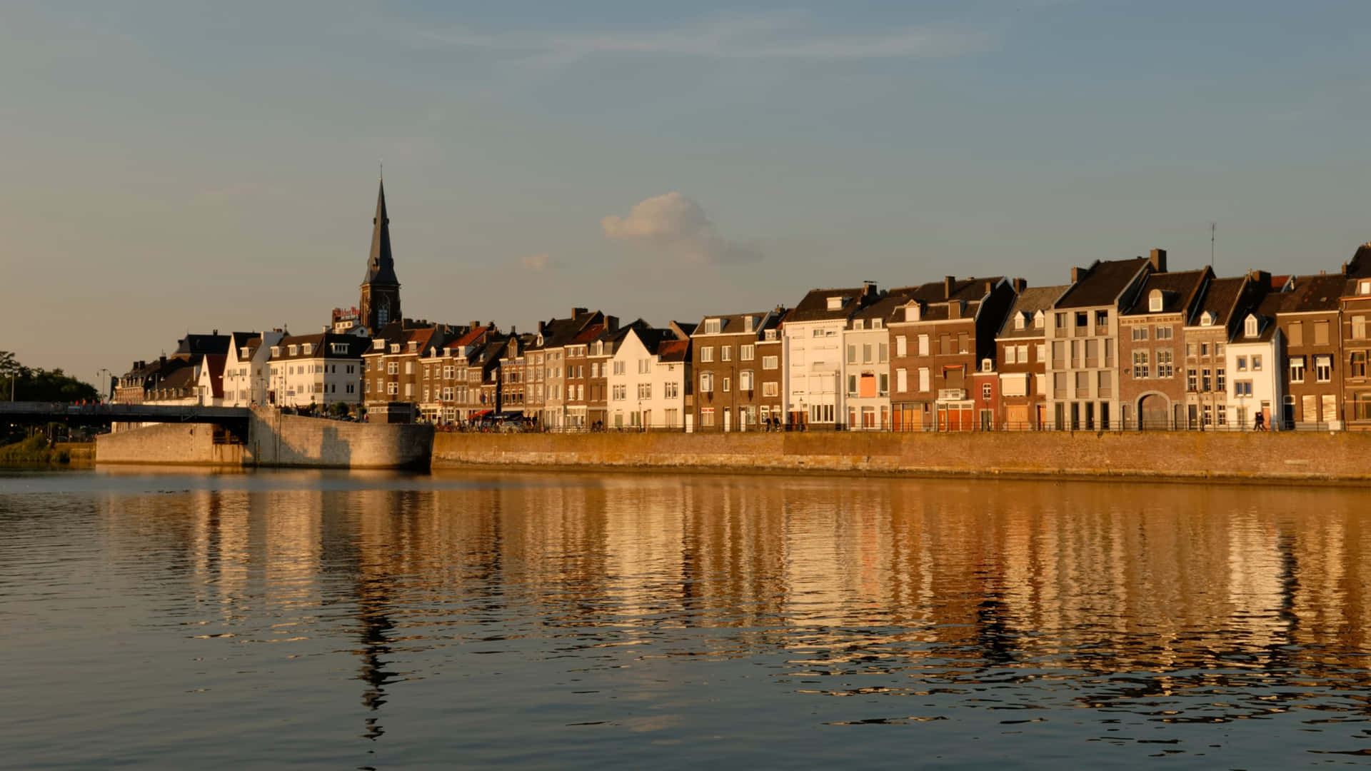 Download Maastricht Riverfront Evening Light Wallpaper | Wallpapers.com