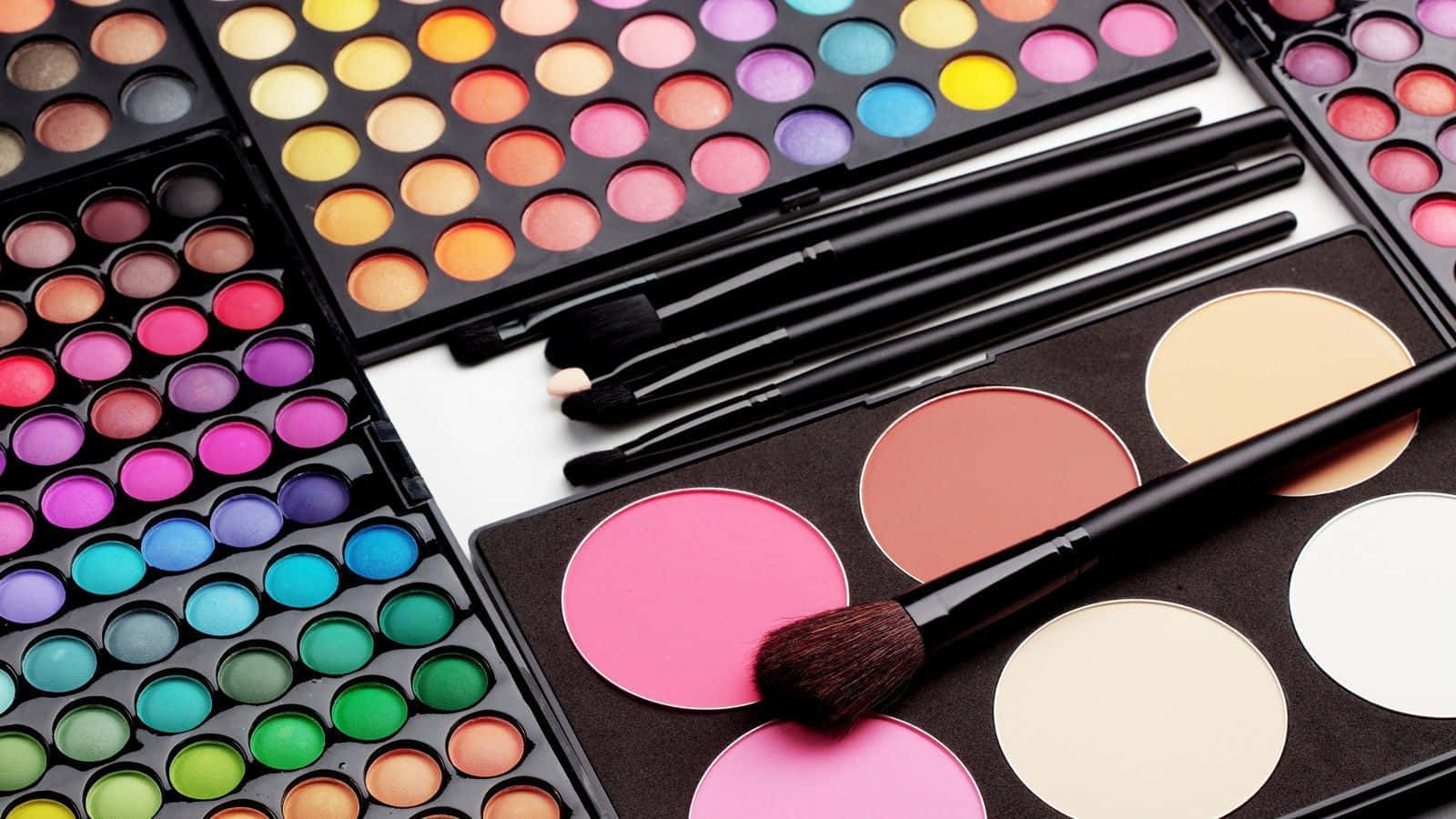 a variety of makeup palettes and brushes