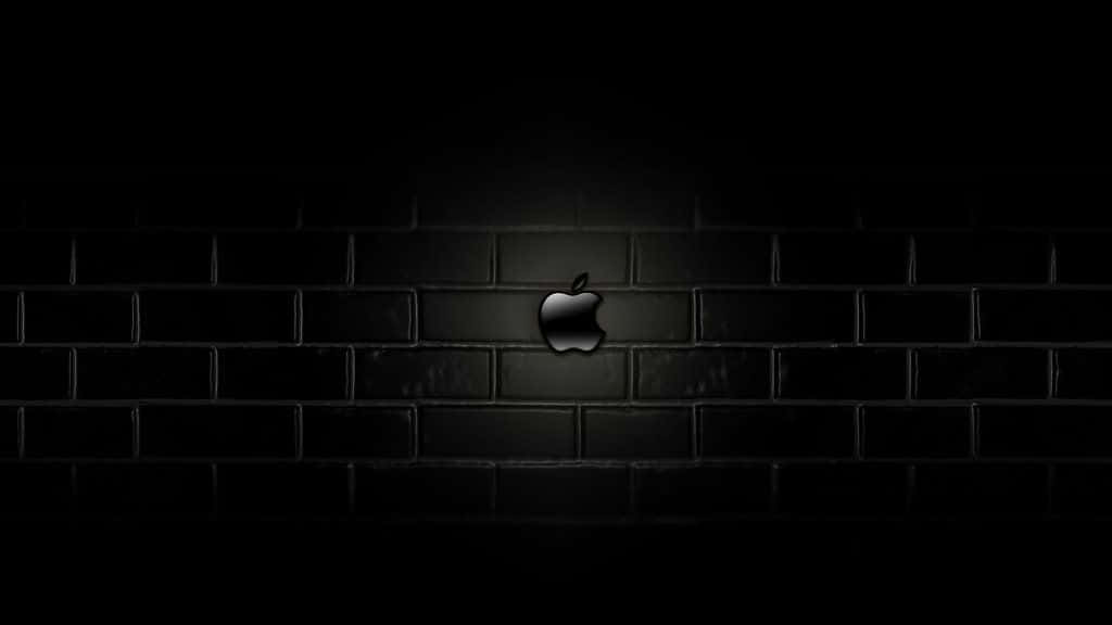 Et æble logo på en mursten mur i mørke Wallpaper