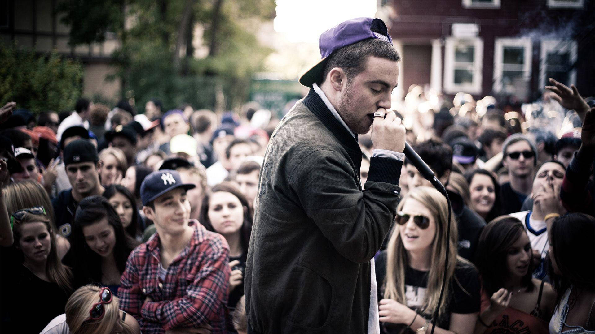 Mac Miller Performing Outdoors With Crowd Wallpaper
