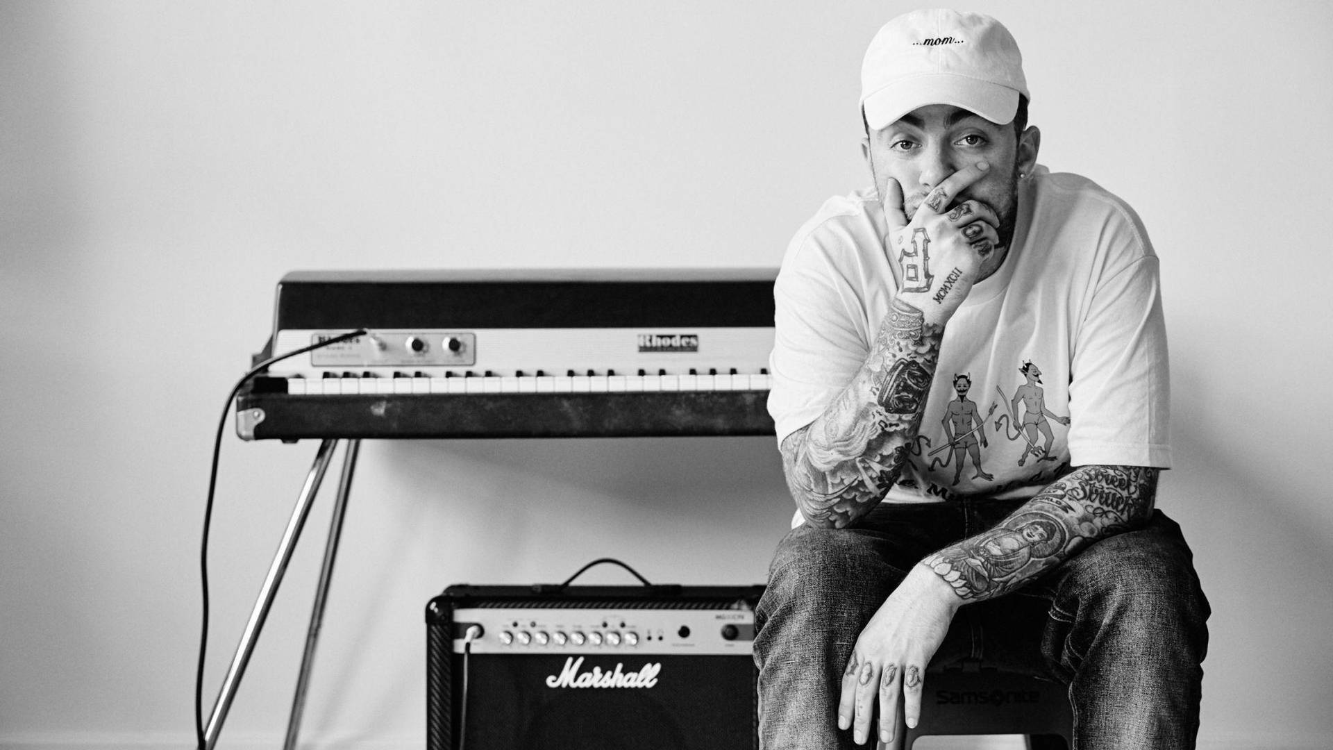 Mac Miller With Synthesizer And Speaker Wallpaper