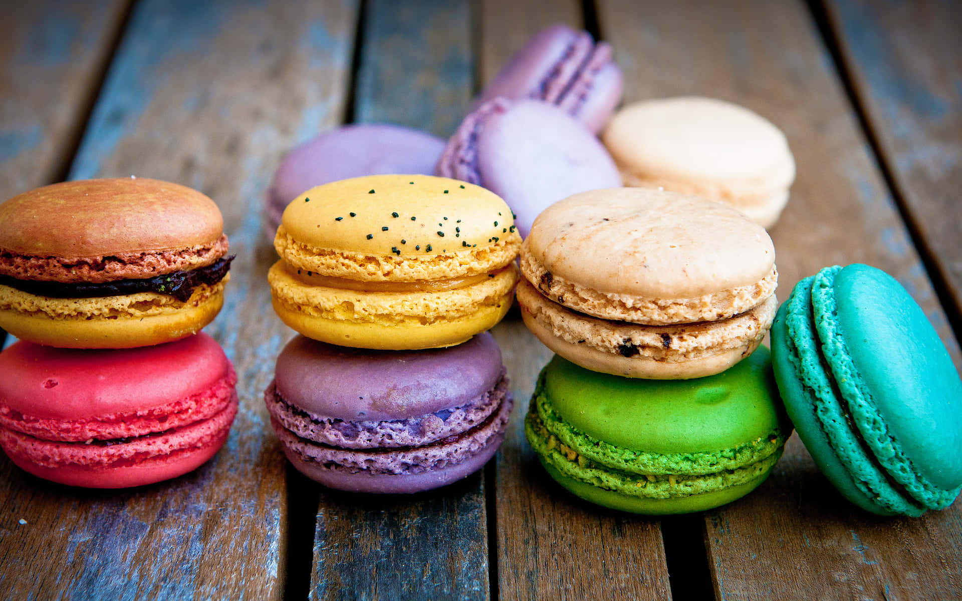 Macaron Stacked On Wooden Surface Wallpaper