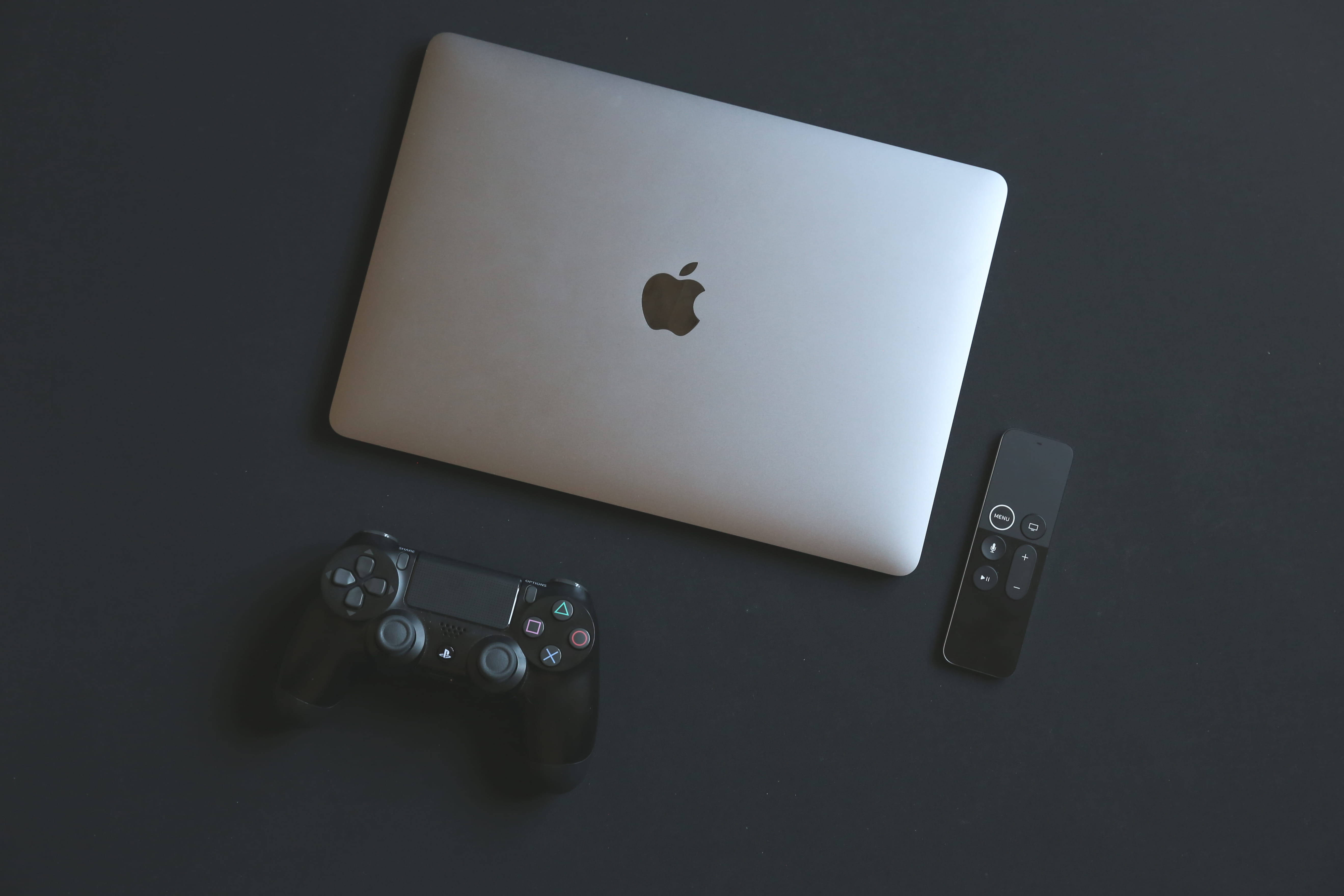 Macbook Gaming Laptop With Black Controller Wallpaper