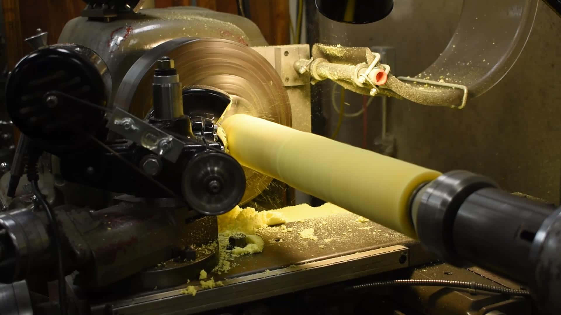 A Machine Is Making A Yellow Tube Wallpaper