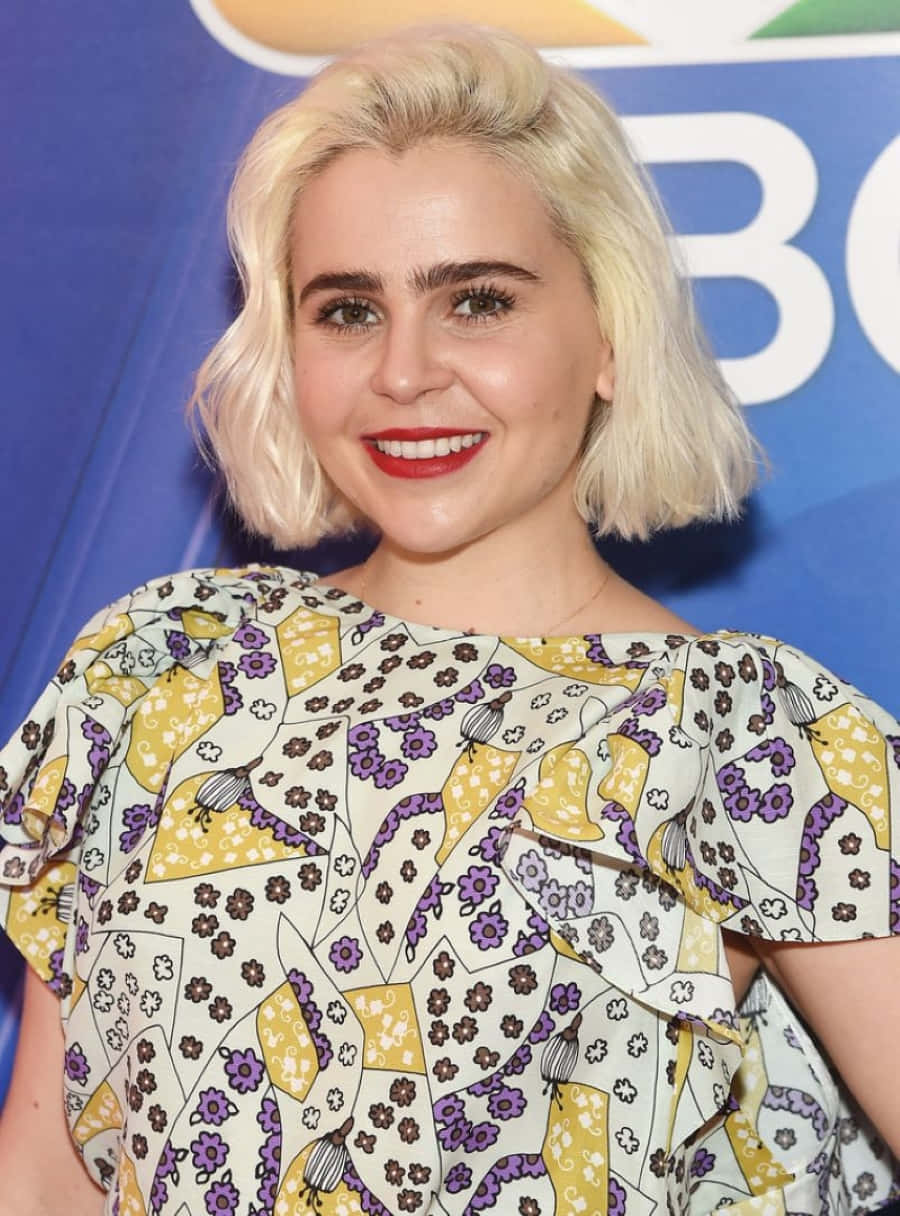 Caption: Mae Whitman radiating beauty in a nature-inspired setting. Wallpaper