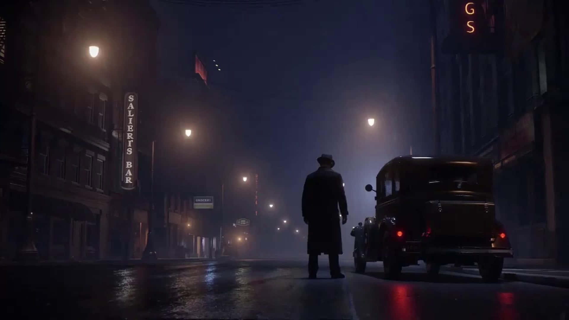 A Man Is Standing In The Dark On A Street