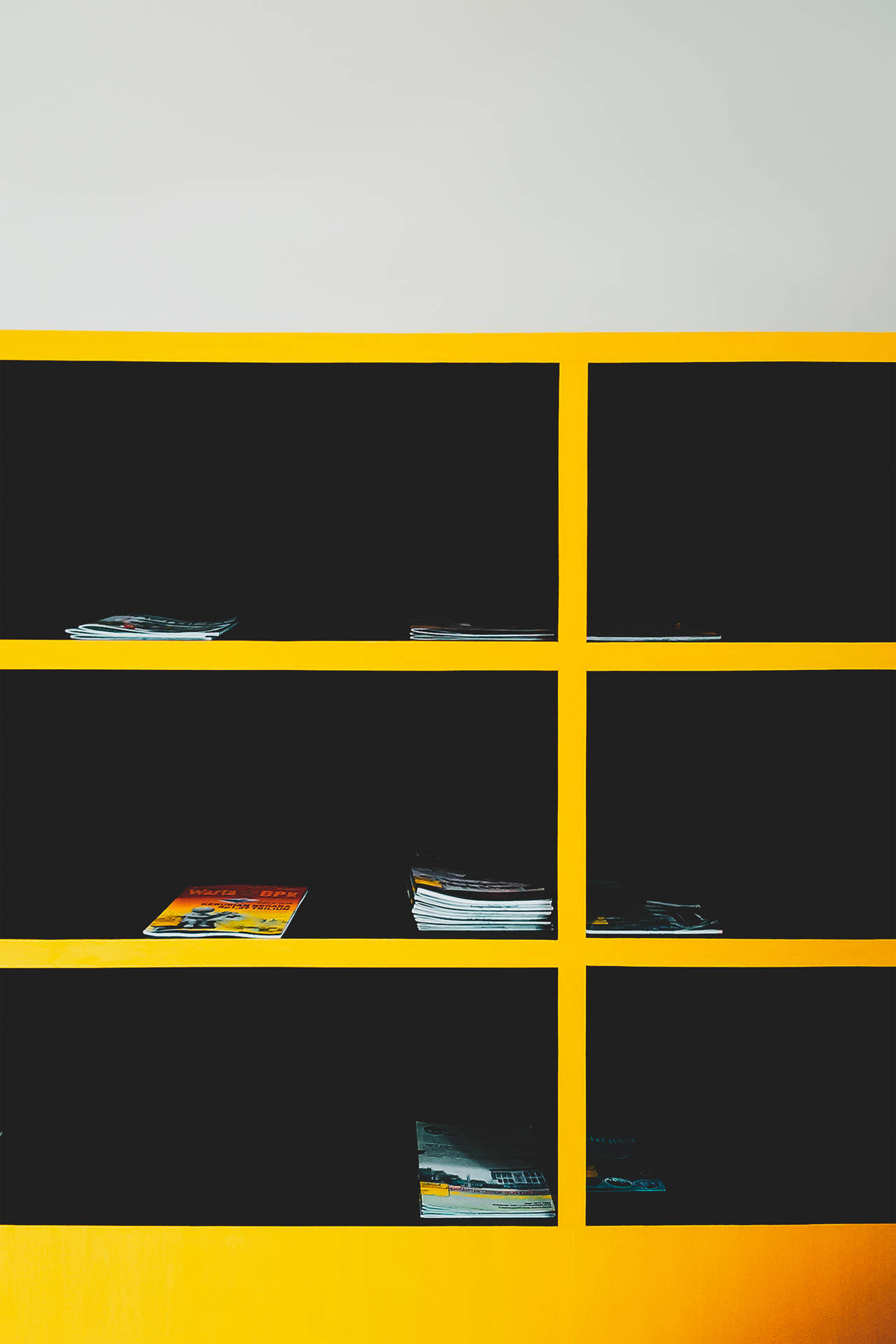 Magazines On Black & Yellow Cabinet