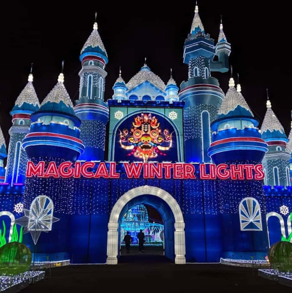 a castle with lights and a sign that says magical winter lights