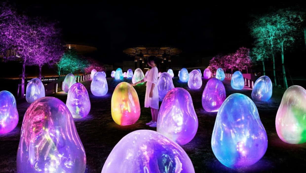 a large group of colorful glowing balls in the dark