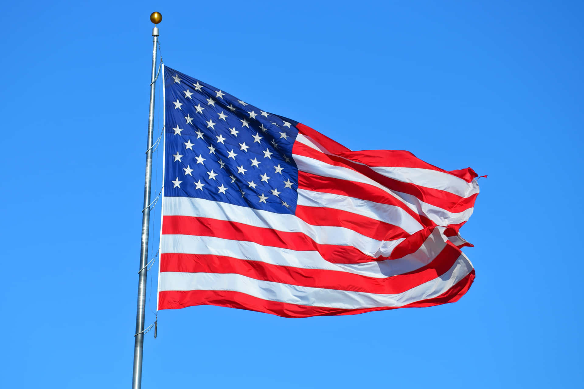 Magnificent U.s. Flag Waving Under The Bright Sunlight Wallpaper