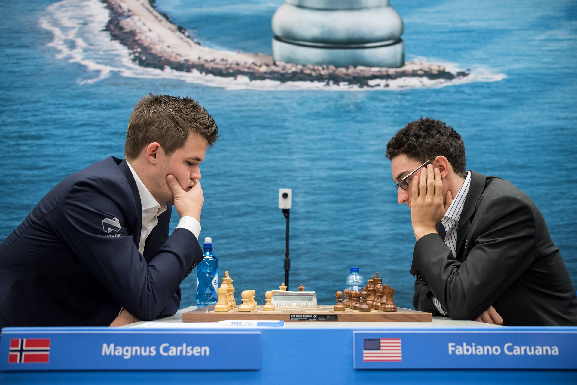 World Chess Champions Magnus Carlsen and Fabiano Caruana in deep contemplation during a match. Wallpaper