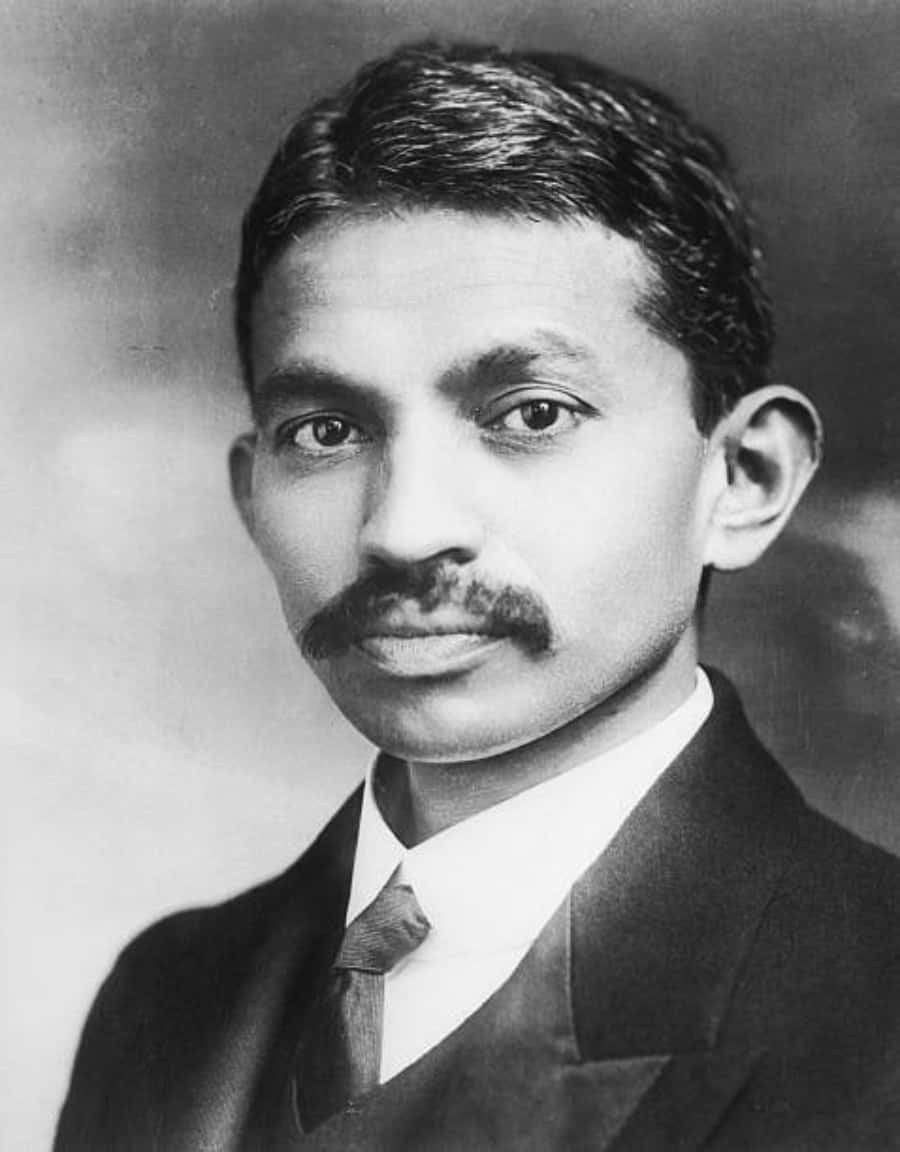 A Man In A Suit And Tie With A Mustache