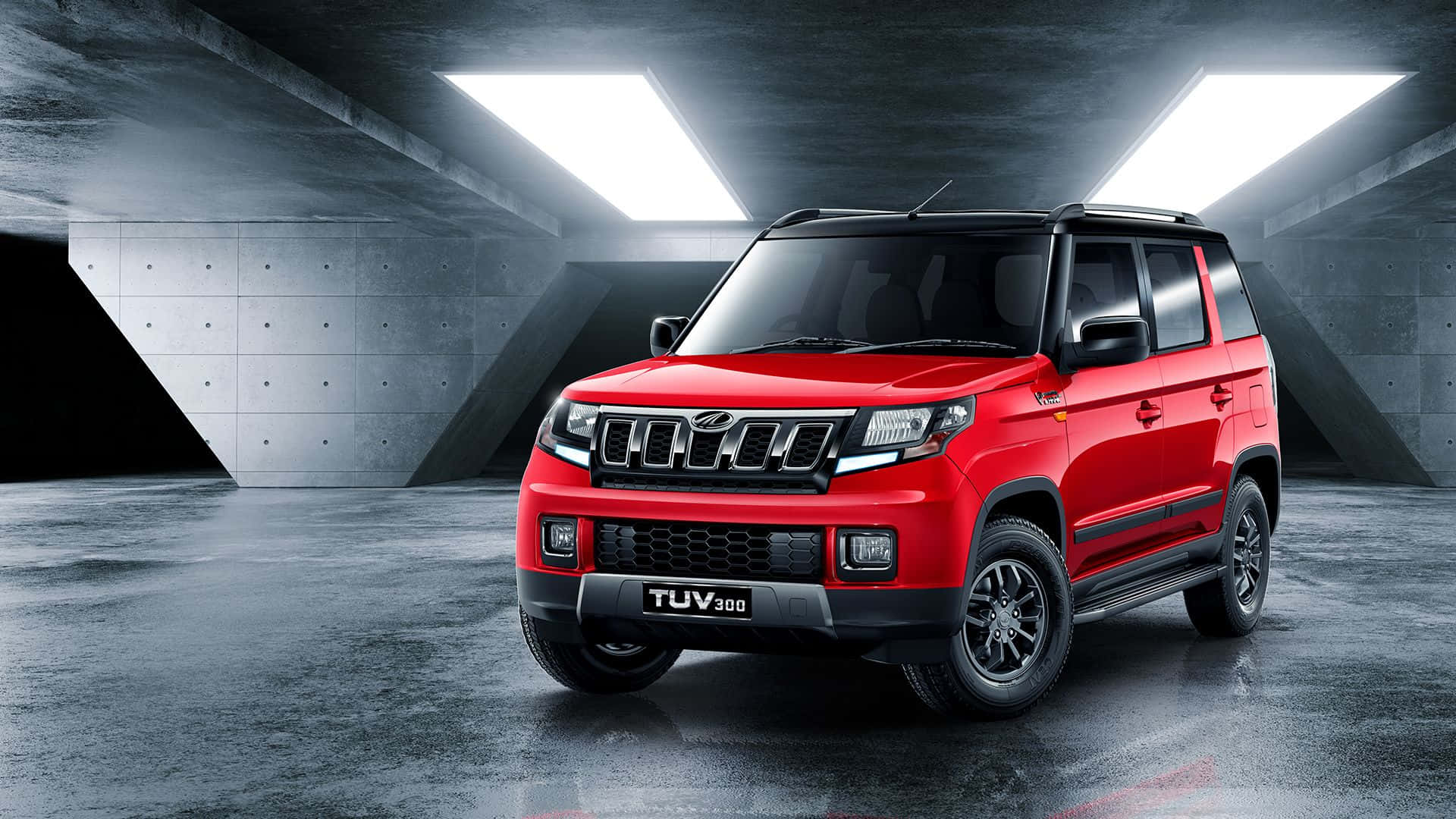 Stylish Mahindra SUV cruising on a picturesque highway Wallpaper