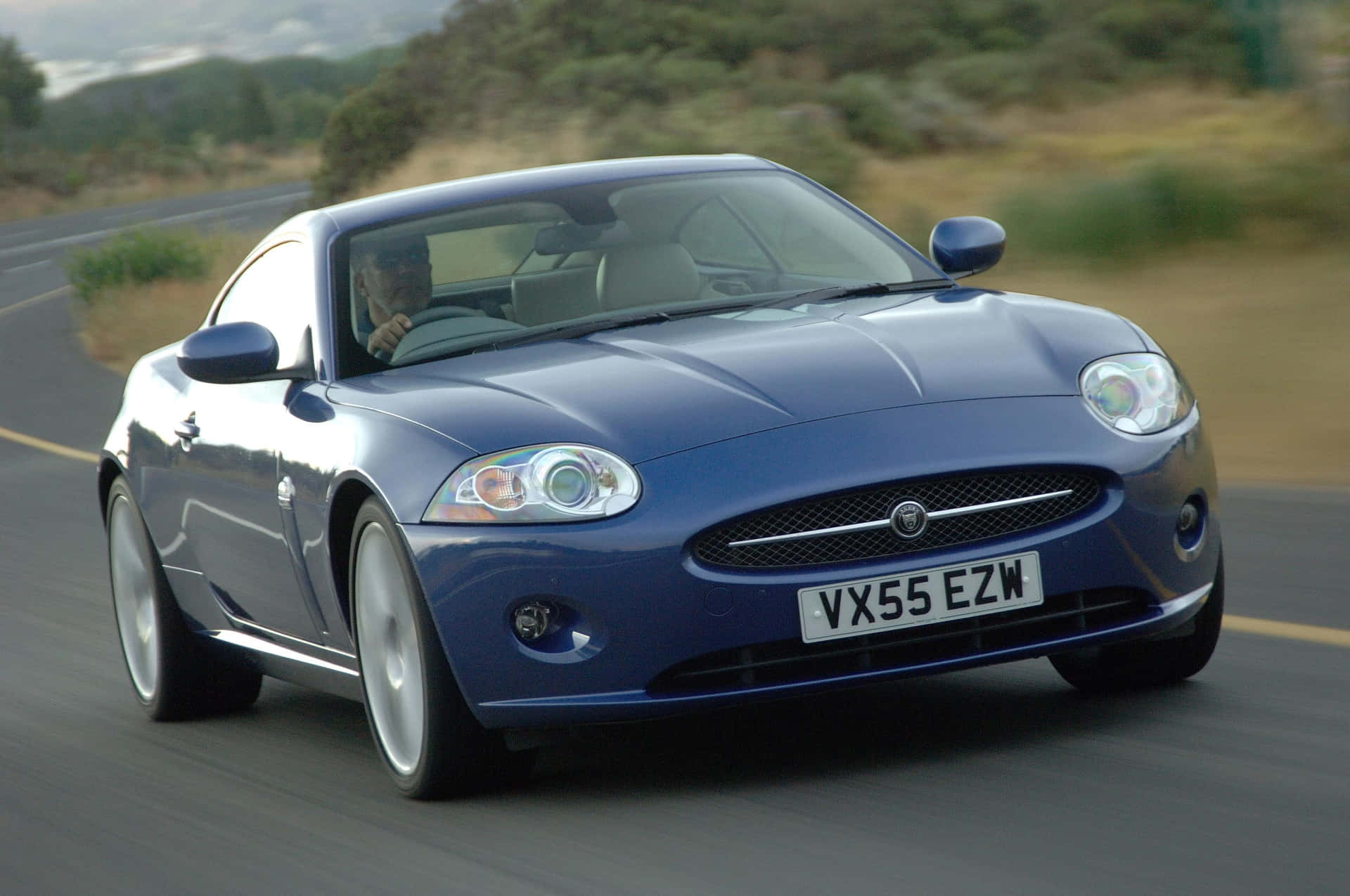 Majestic Black Jaguar Xk Under Starlit Night Sky. Wallpaper