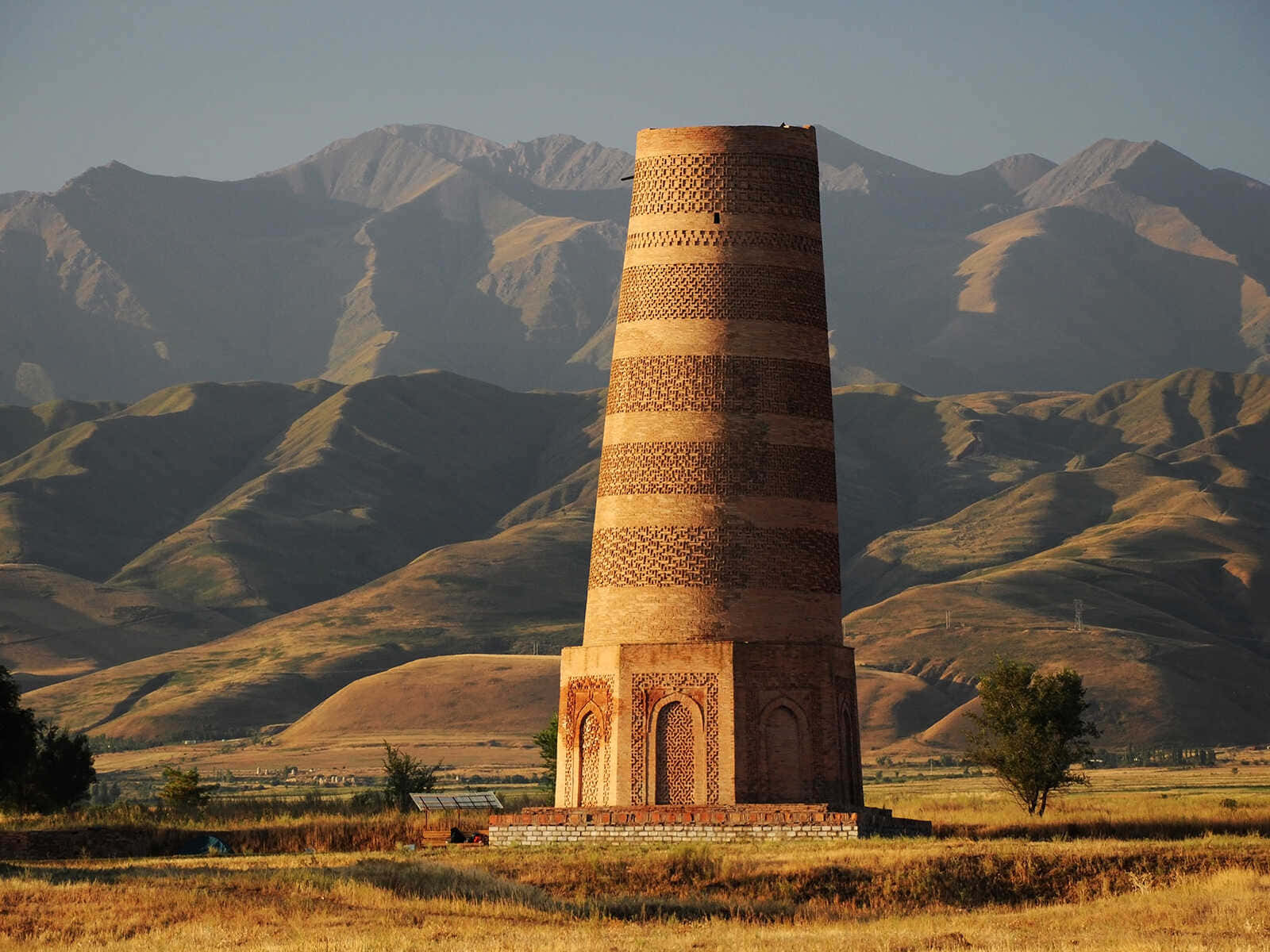 Majestic Burana Tower Against A Clear Blue Sky Wallpaper
