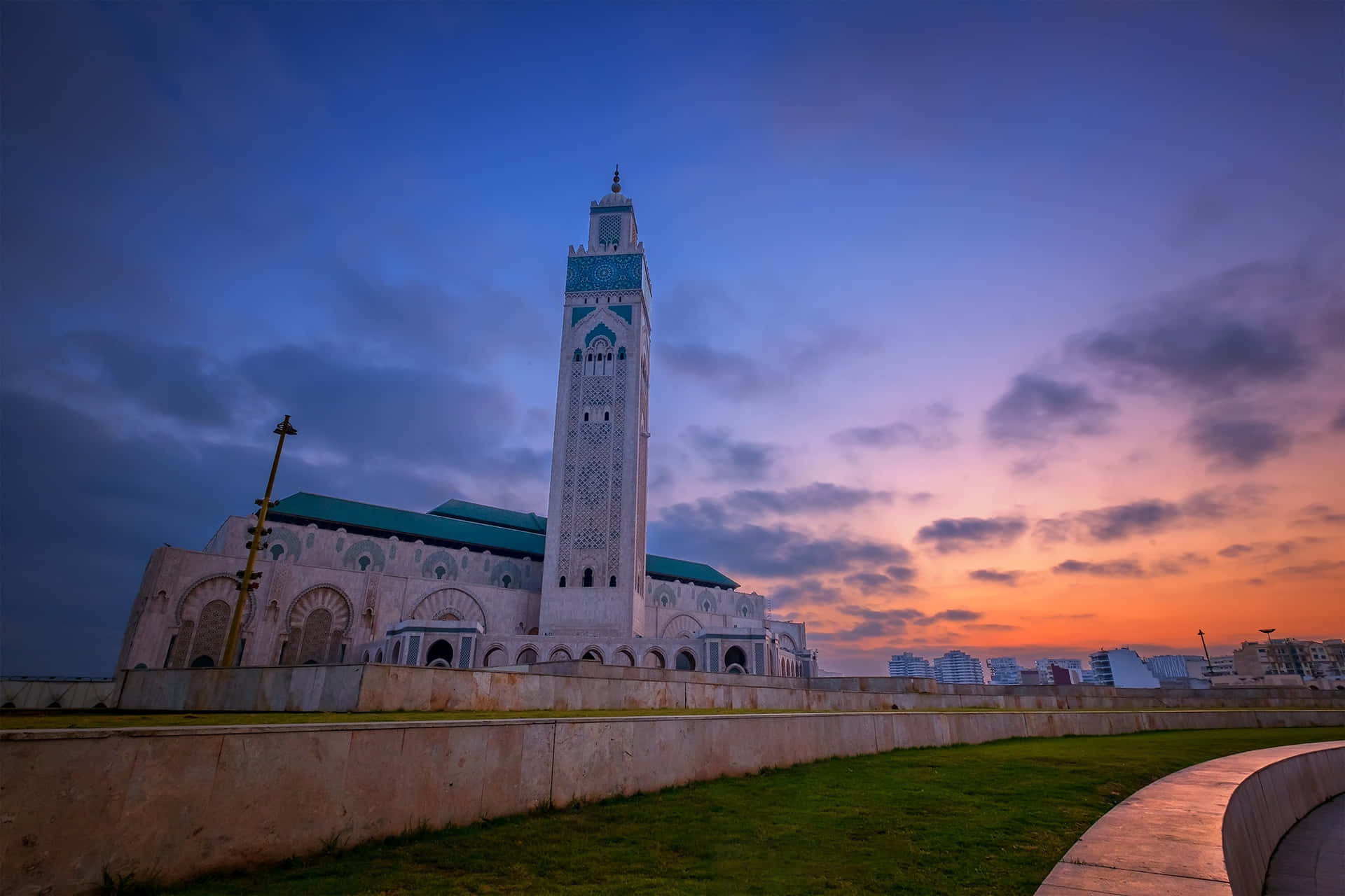 Majestic Hassan Ii Mosque At Sunset Wallpaper