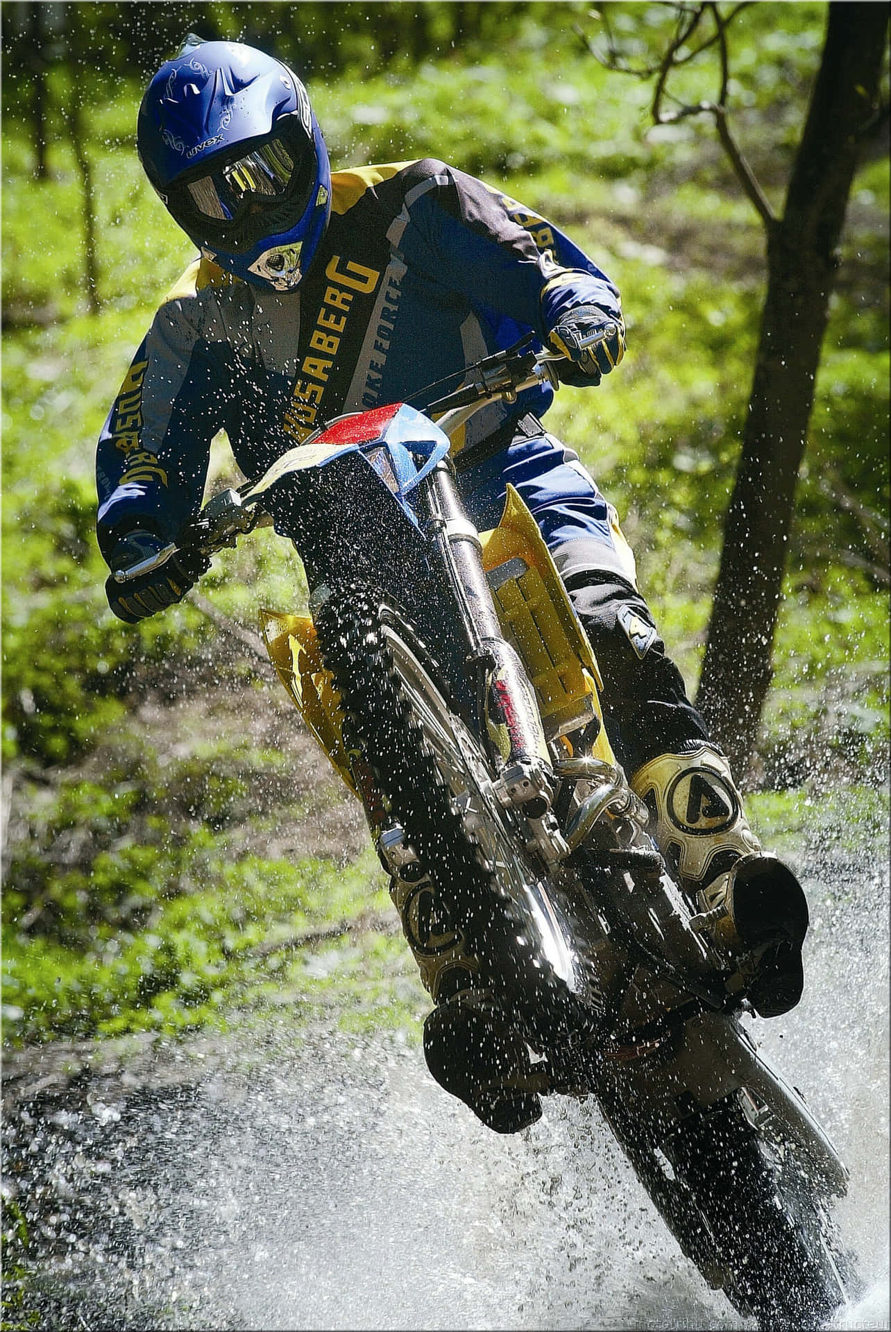 Majestic Husaberg Motorcycle Cruising On A Sunny Road Wallpaper