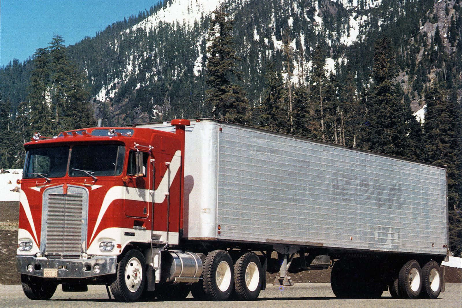 Majestic Kenworth K100 Semi-truck On The Open Road Wallpaper