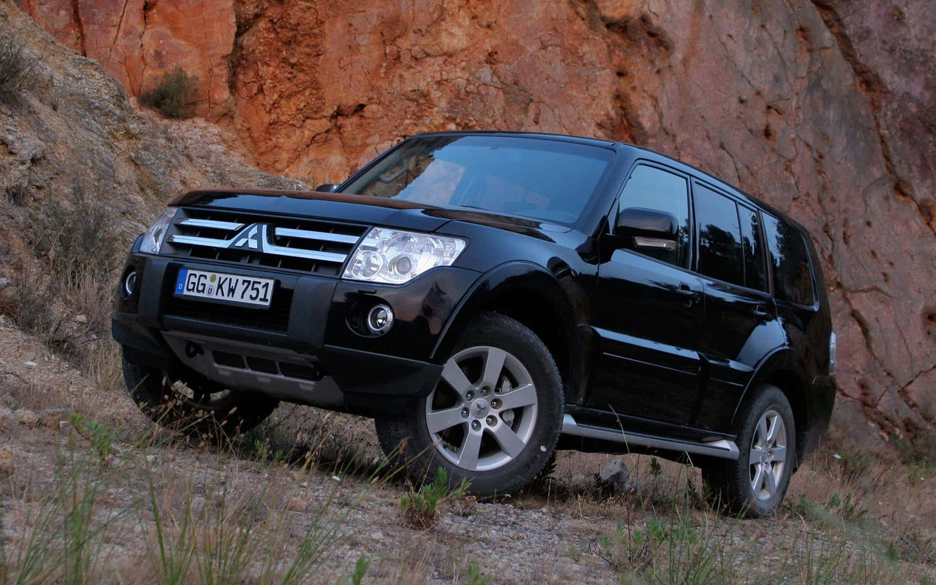 Majestic Mitsubishi Pajero Suv In Raw Nature Wallpaper