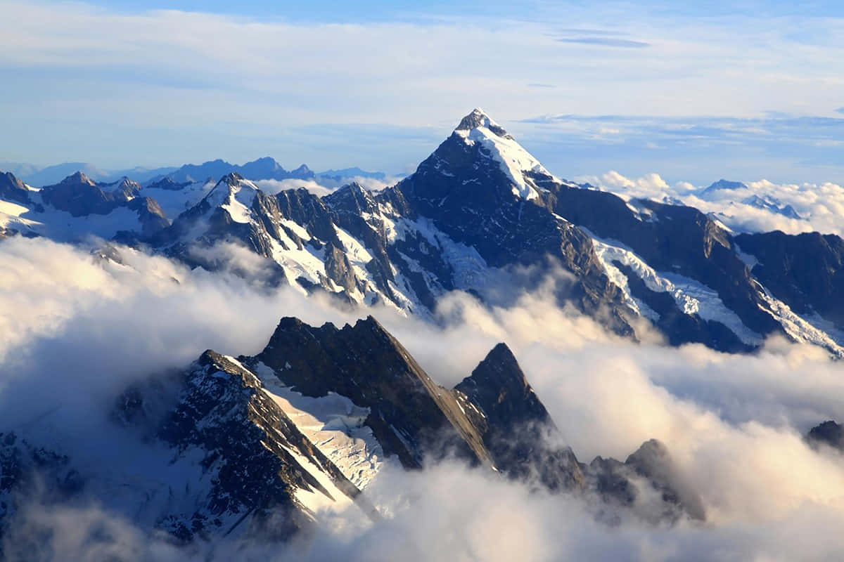 Majestic_ Mountain_ Peak_ Above_ Clouds.jpg Wallpaper