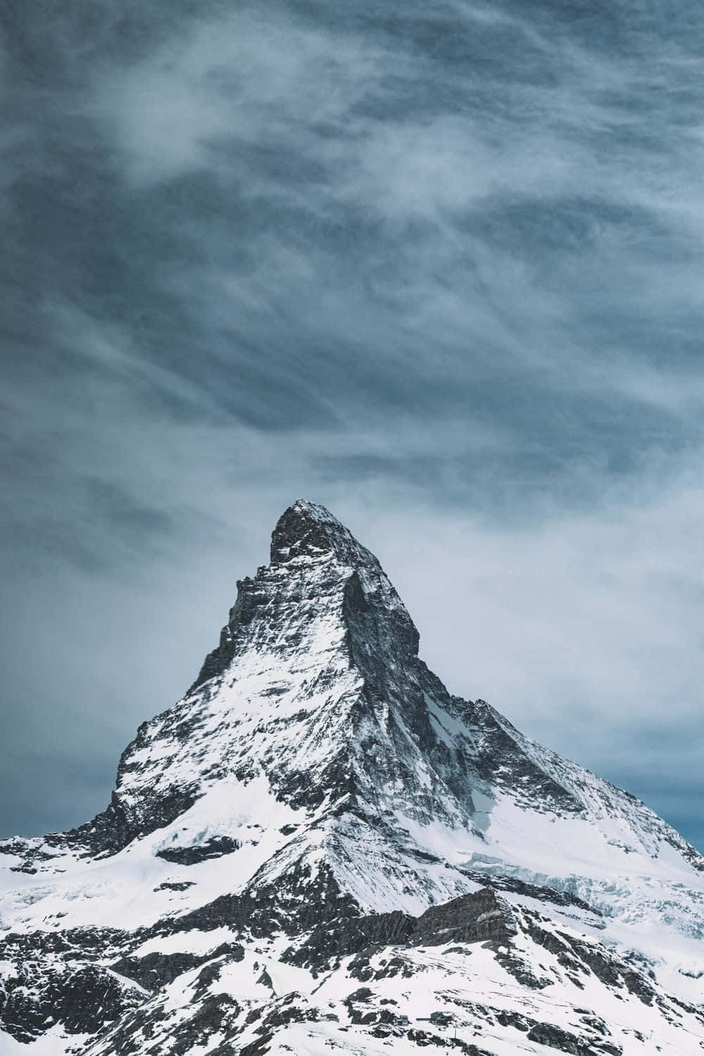 Majestic_ Mountain_ Peak_ Under_ Cloudy_ Skies.jpg Wallpaper