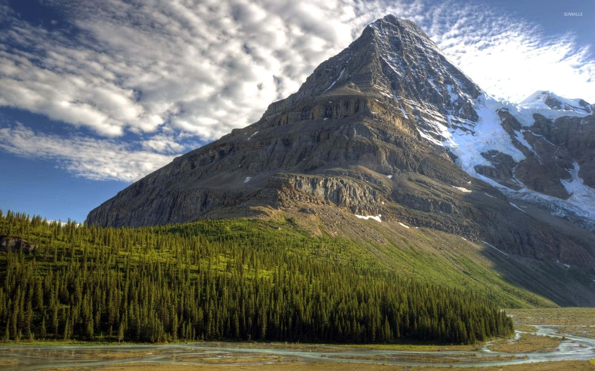 Majestic_ Mountain_ Peak_with_ Forest_and_ Clouds.jpg Wallpaper