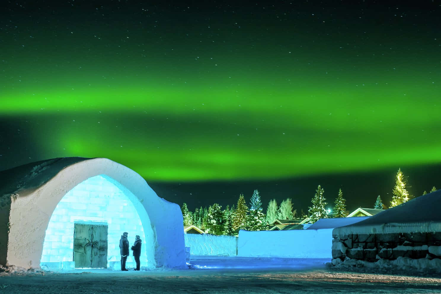 Majestic Northern Lights Dancing Over Kiruna Skyline Wallpaper