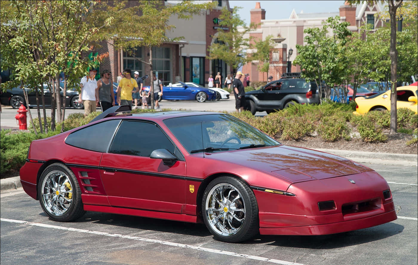 Majestic Pontiac Fiero Posing Under The Clear Blue Sky Wallpaper