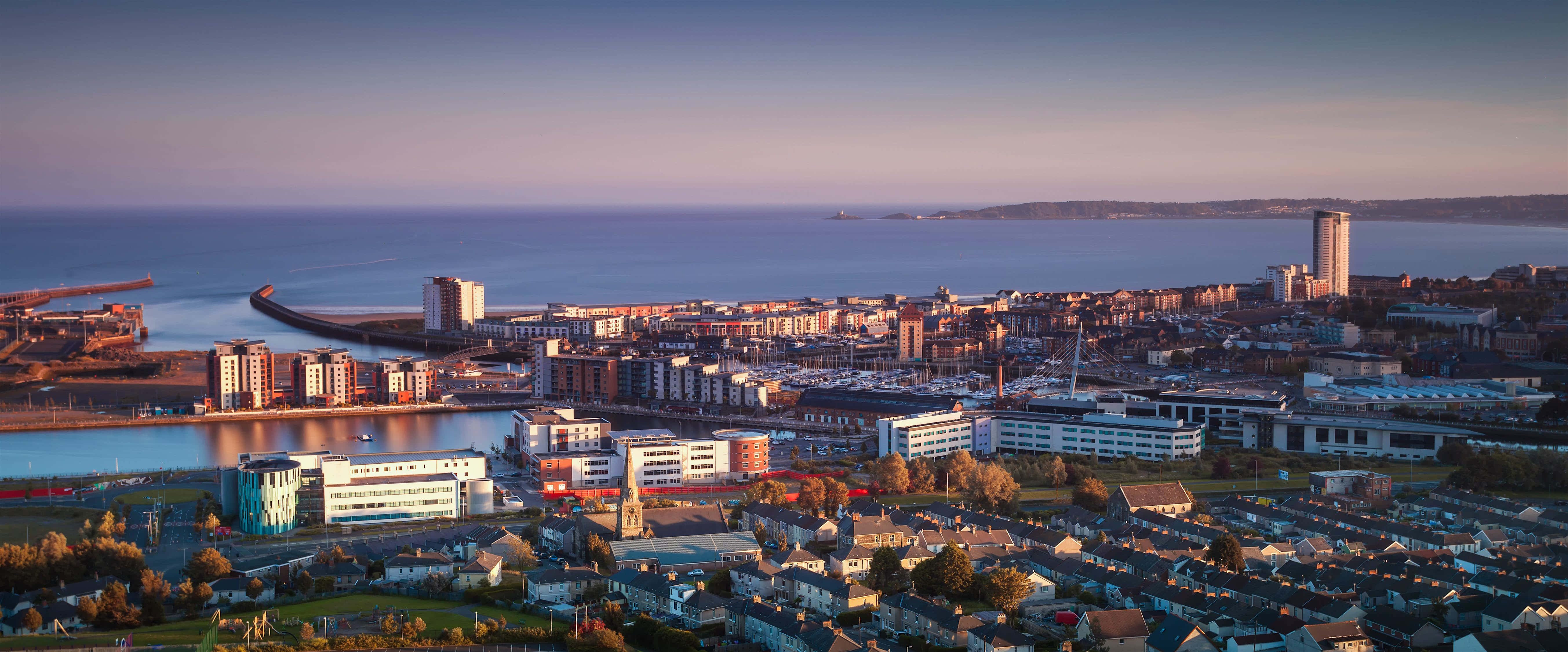 Majestic View Of Swansea Cityscape During Twilight Wallpaper