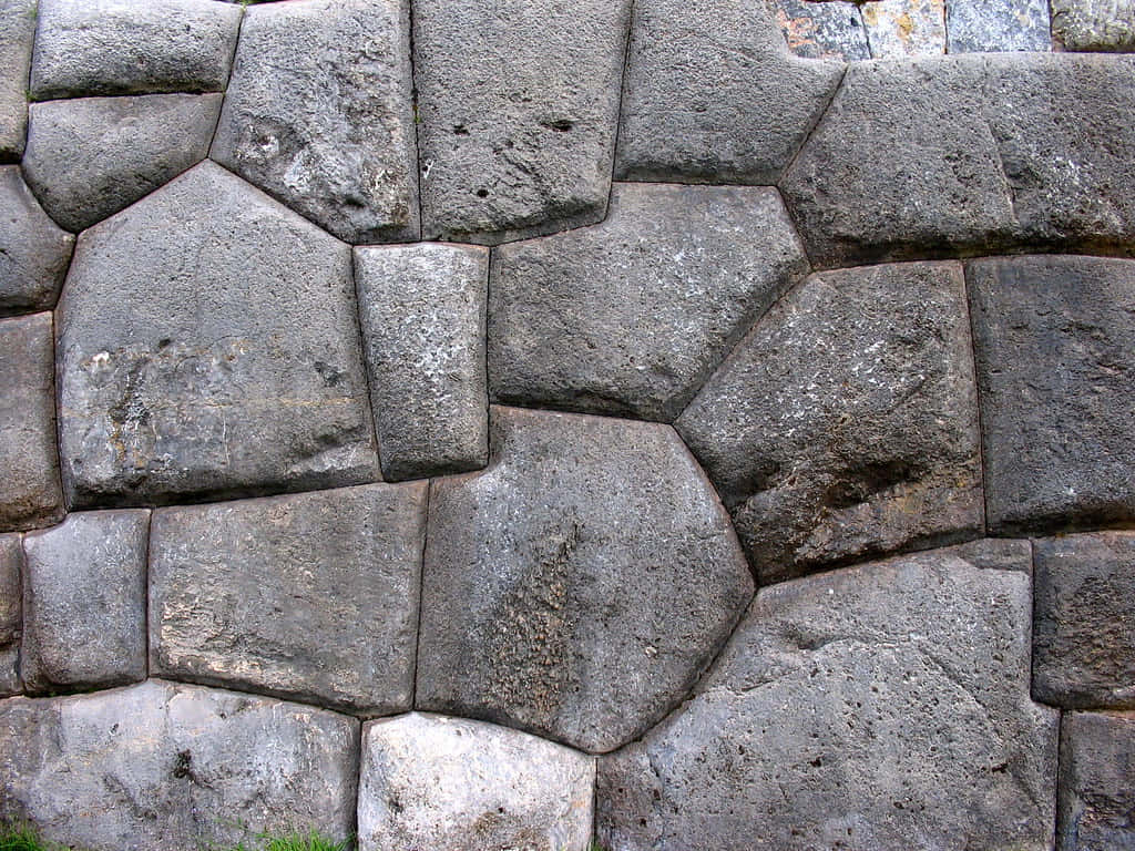 Majestic View Of The Ancient Stone Walls Of Sacsayhuaman, Cusco, Peru Wallpaper