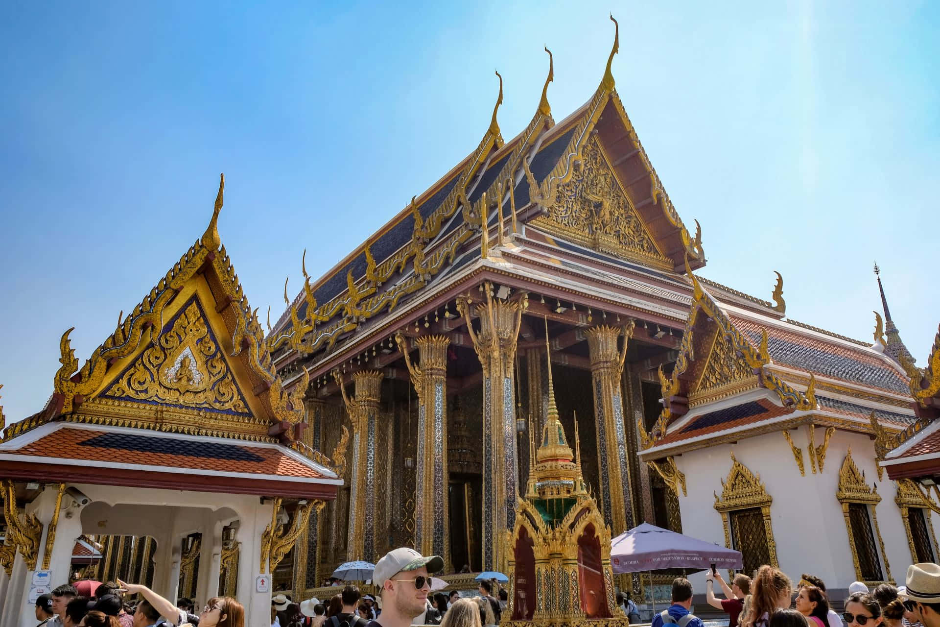 Majestic View Of The Grand Palace Glittering Under The Blue Sky Wallpaper