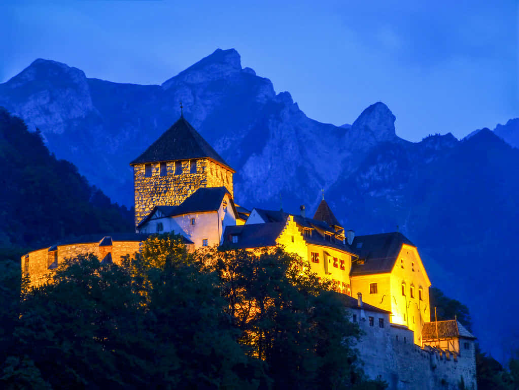 Majestic View Of Vaduz Castle Against Bright Blue Sky Wallpaper