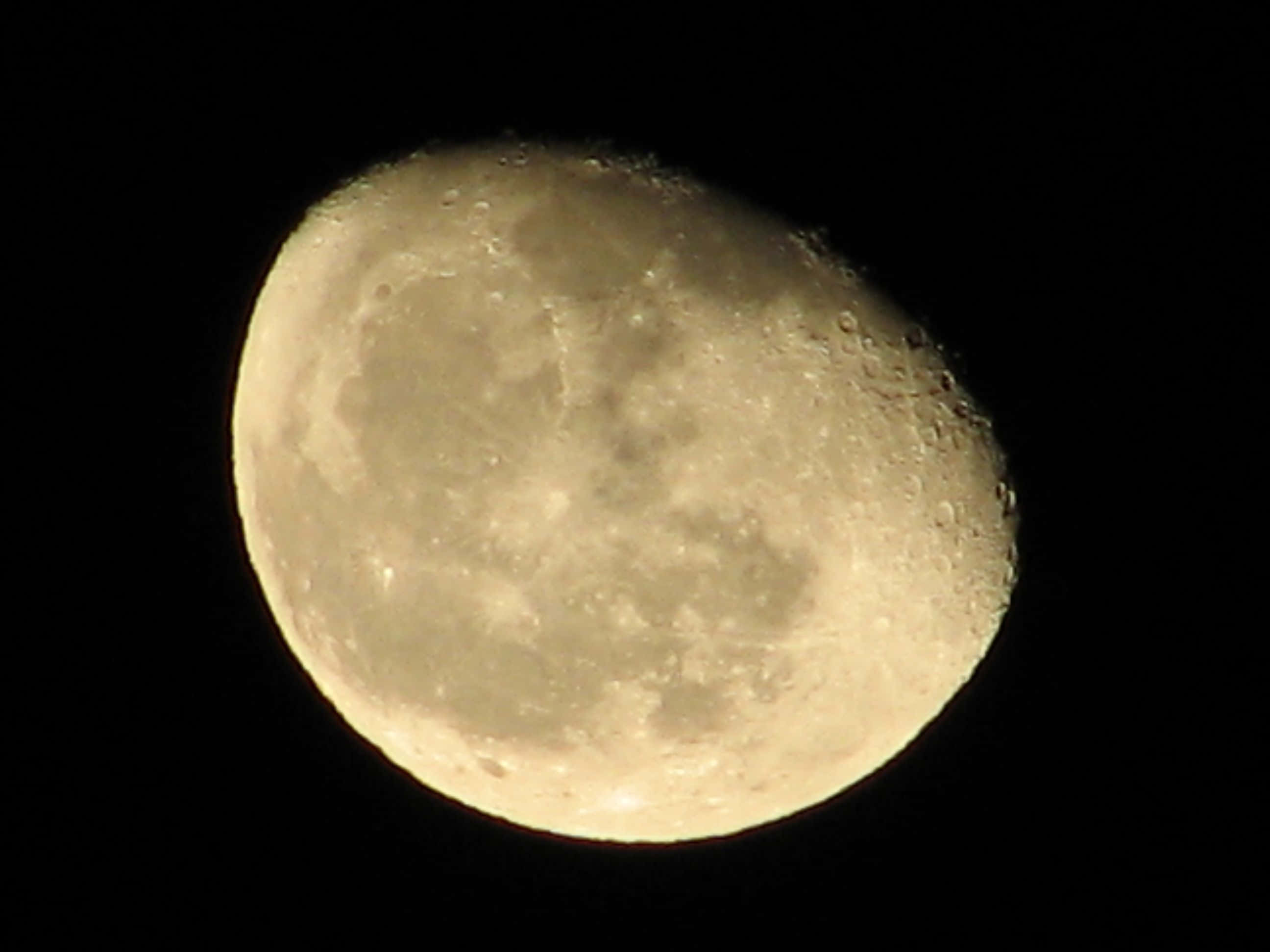Majestic Waning Gibbous Moon In The Night Sky Wallpaper