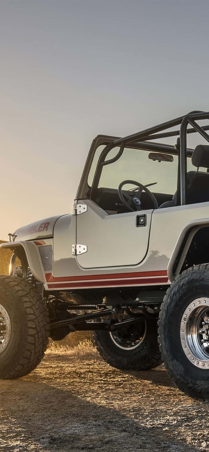 Majesty In Motion - Vintage Jeep Cj Cruising On A Sunlit Trail Wallpaper