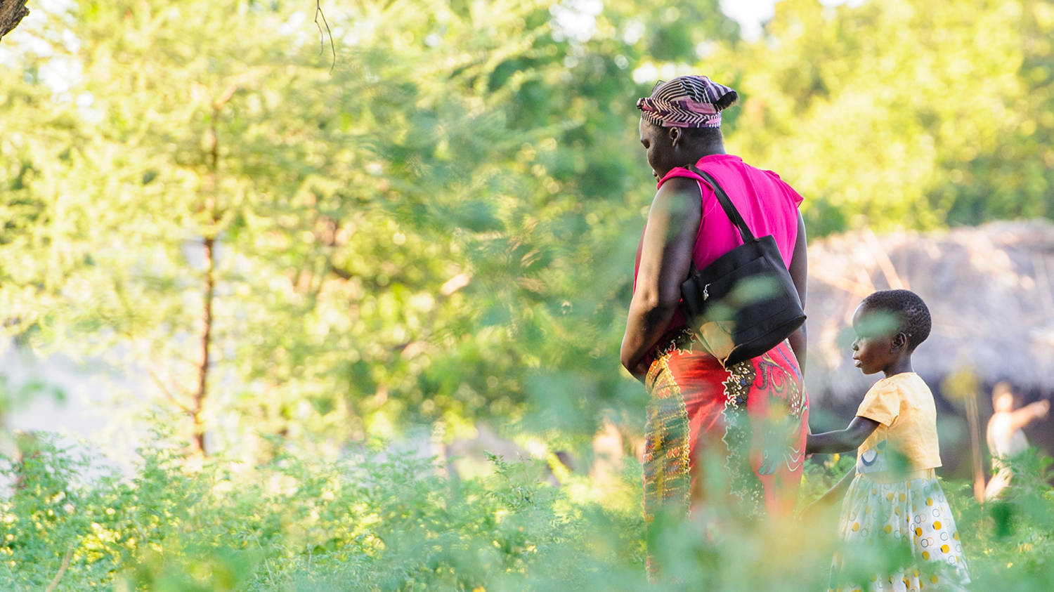 Malawi Woman Walking With Child Wallpaper