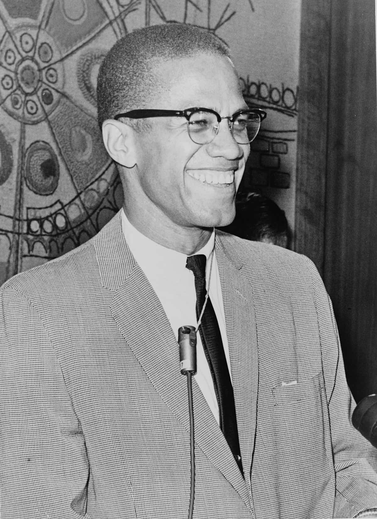 Malcolm X Smiling Blackand White Portrait Wallpaper