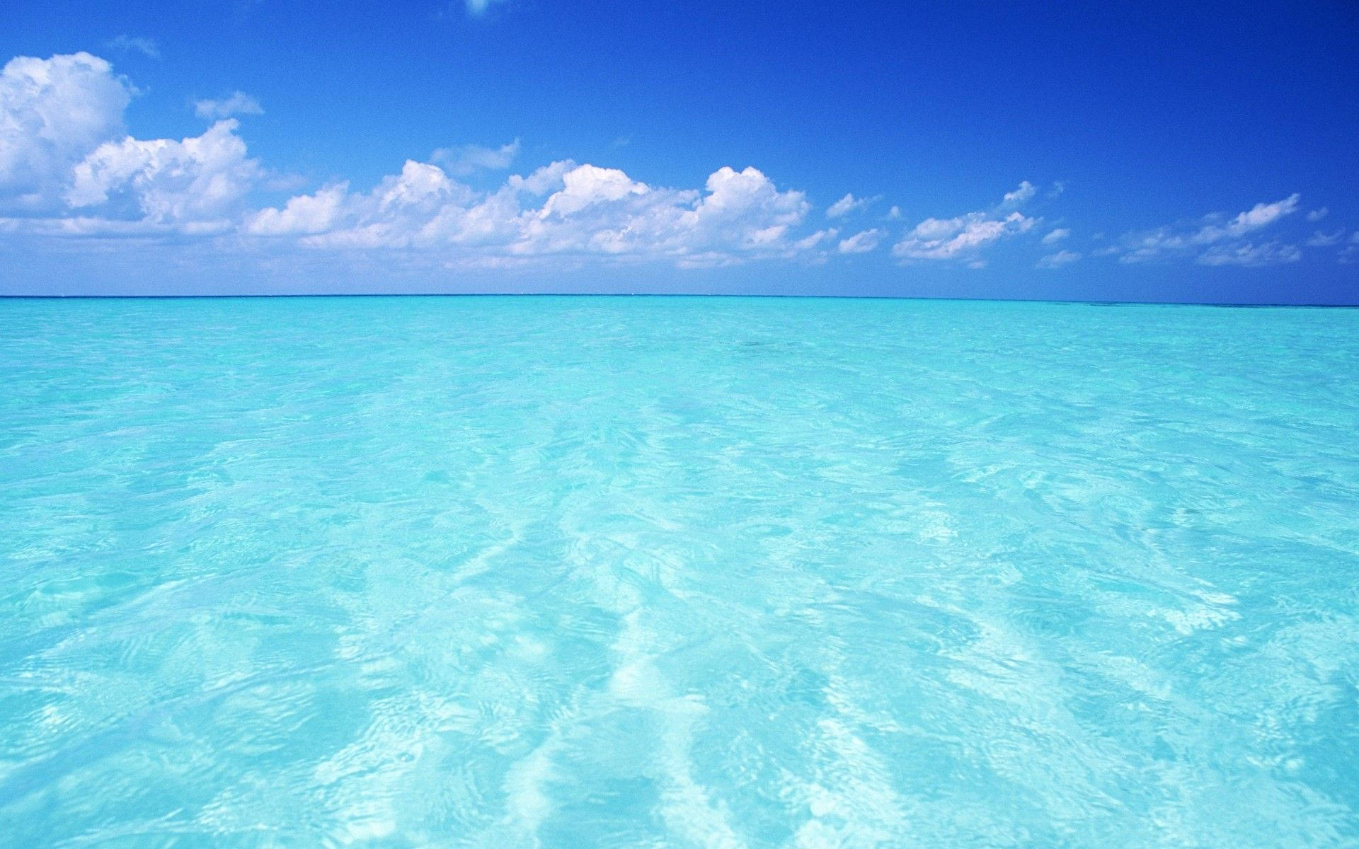 A clear beach and sky in Maldives Desktop wallpaper.