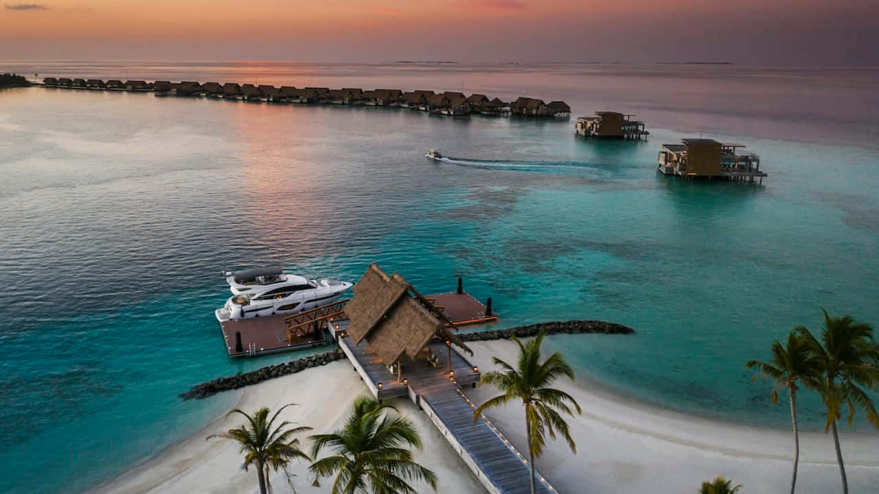 Pristine Beaches and Aquamarine Waters of Maldives Island Wallpaper