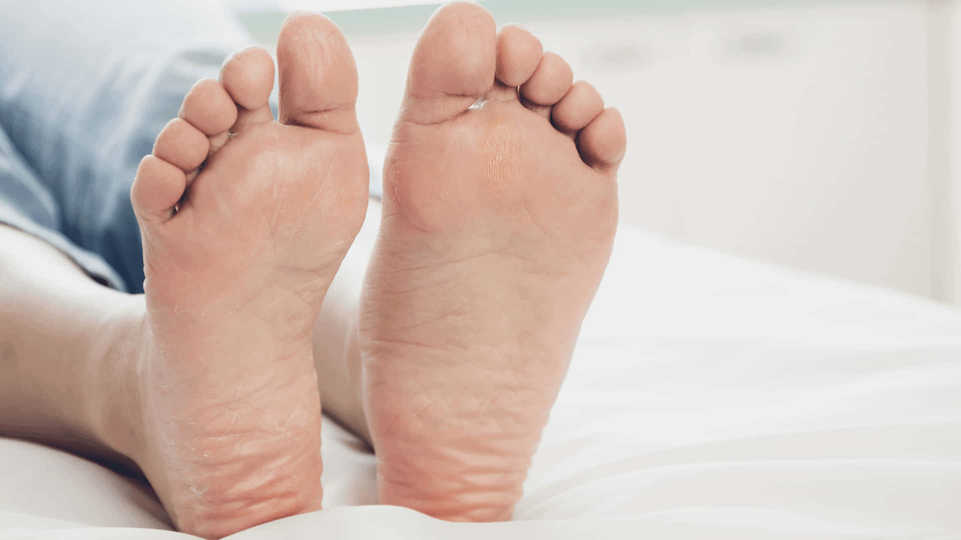 Man Relaxing on Bed - Closeup of Male Feet Wallpaper