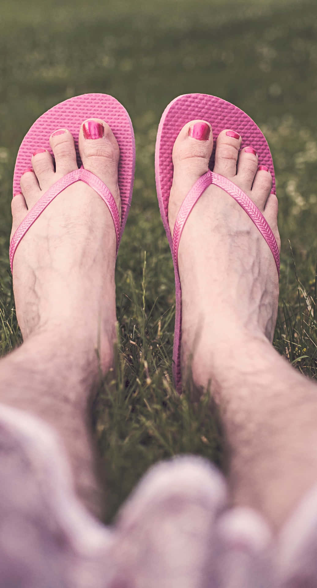Male Feet With Pink Nail Polish And Slippers Wallpaper