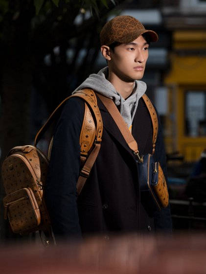 Male Model Carrying MCM Bag Wallpaper