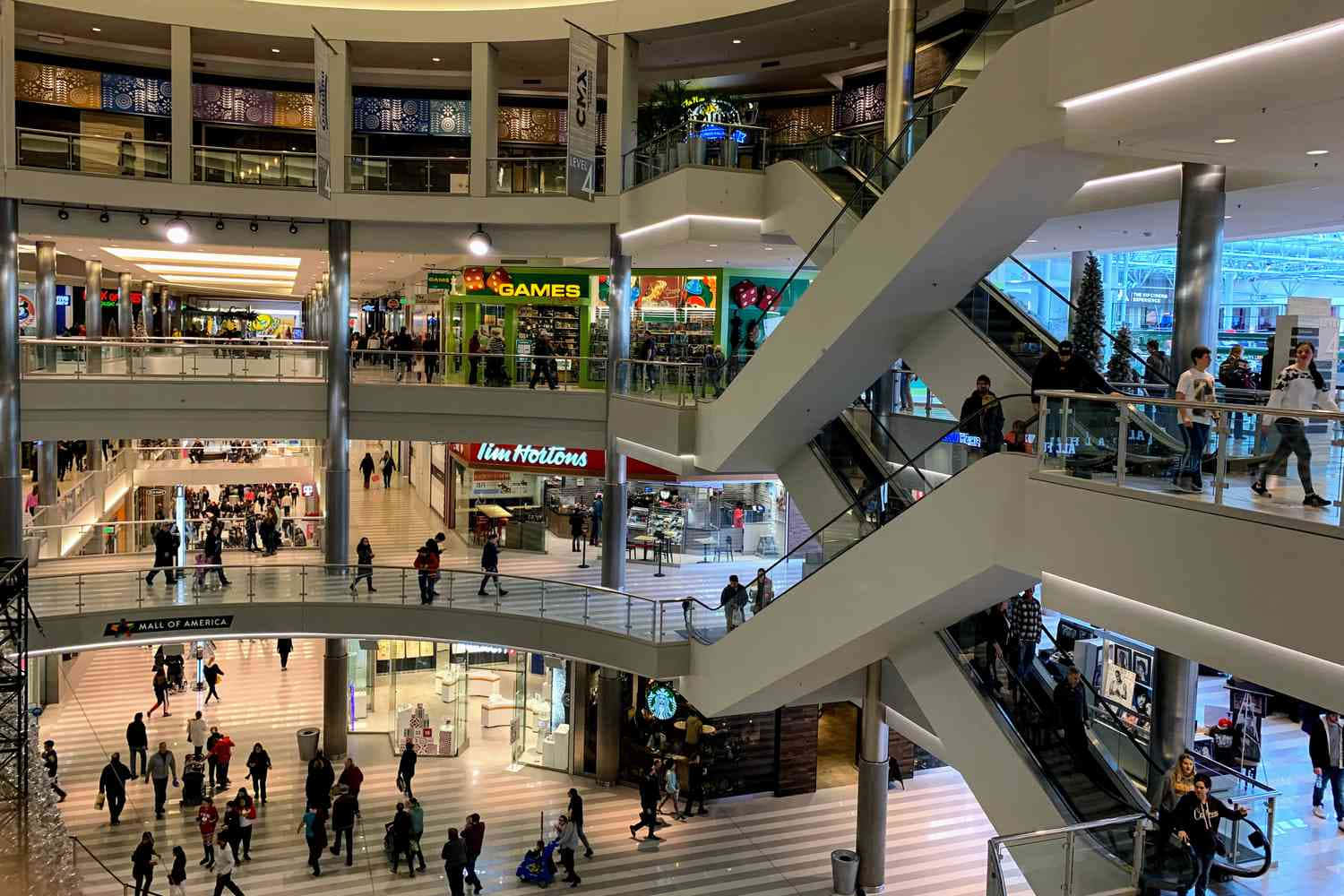 A bustling shopping mall with modern architecture and happy shoppers