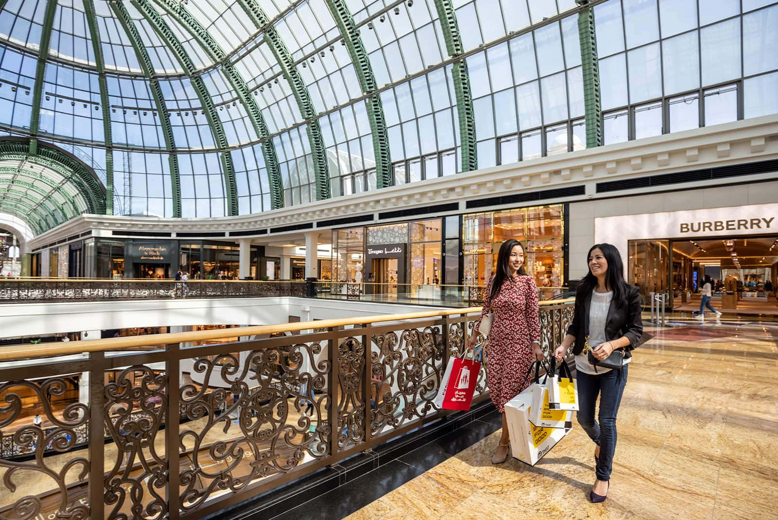 Bustling shopping mall with various stores and a lively atmosphere