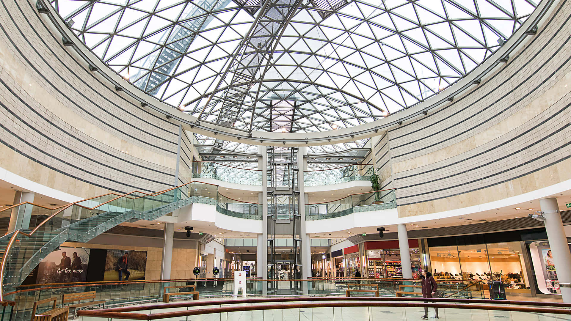 A bustling, vibrant mall with shoppers browsing the latest trends and enjoying leisure activities.